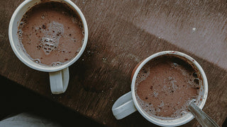 Two cups of hot cocoa representign the sign of Gemini and the Cold Moon