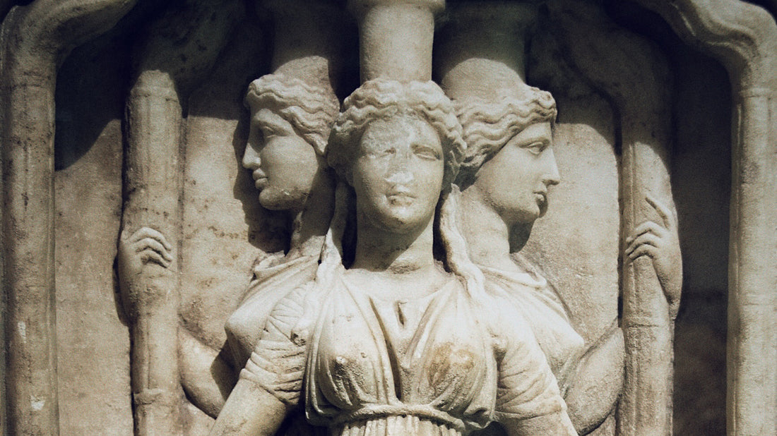 Ancient sculpture of Hekate, depicted in her triple form with three heads and bodies conjoined, holding torches, symbolizing her dominion over the crossroads and her role as a light-bringer in Greek mythology.