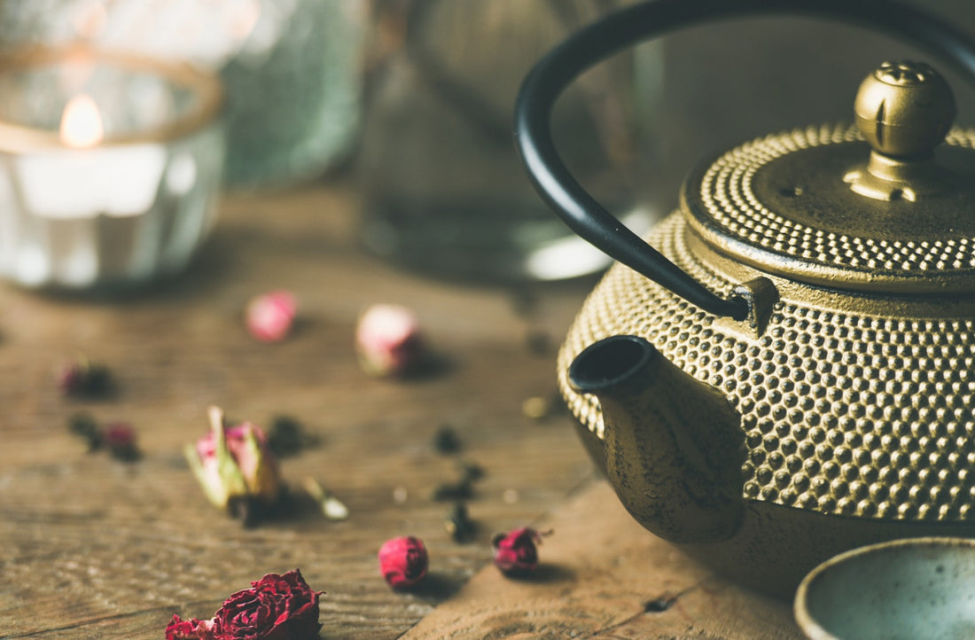 A vintage teapot on a rustic wooden table, surrounded by scattered dried rose petals and tea leaves, reminiscent of the Tsukumogami lore, where everyday objects awaken with spirits in the enchanting world of Japanese magic.
