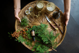 A collection of Yule Altar Items on a basket.