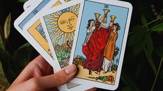 an image of the raider waite version of the three of cups tarot card aginst a dark background